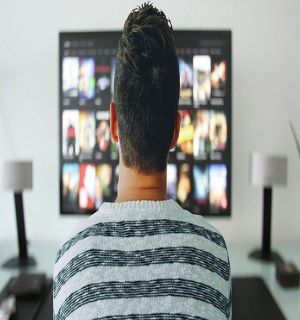 the man sitting in front of TV